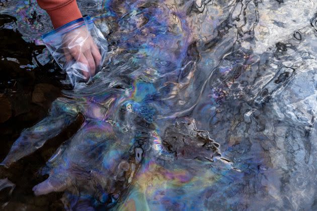 A water sample is collected from Leslie Run, a creek in East Palestine, Ohio, on Feb. 25.