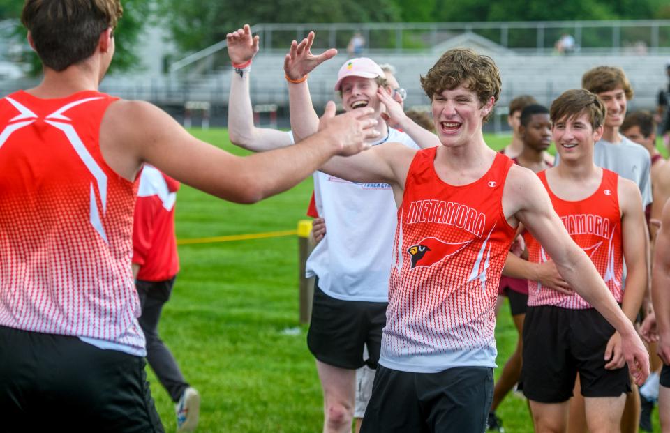 The Metamora Redbirds celebrate their second-place and state-qualifying finish in the 4X800-meter relay during the Class 2A Metamora Sectional track and field meet Wednesday, May 18, 2022 at Metamora High School. The Redbirds finished second to Olympia.