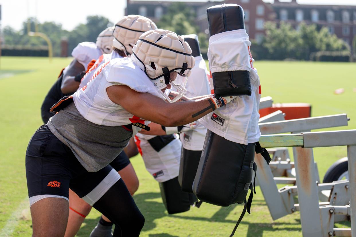 Players runs drills during an Oklahoma State football practice in Stillwater, Okla., on Saturday, Aug. 3, 2024.