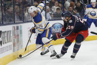 Buffalo Sabres' Rasmus Dahlin, left, and Columbus Blue Jackets' Yegor Chinakhov fight for a loose puck during the second period of an NHL hockey game on Wednesday, Dec. 7, 2022, in Columbus, Ohio. (AP Photo/Jay LaPrete)