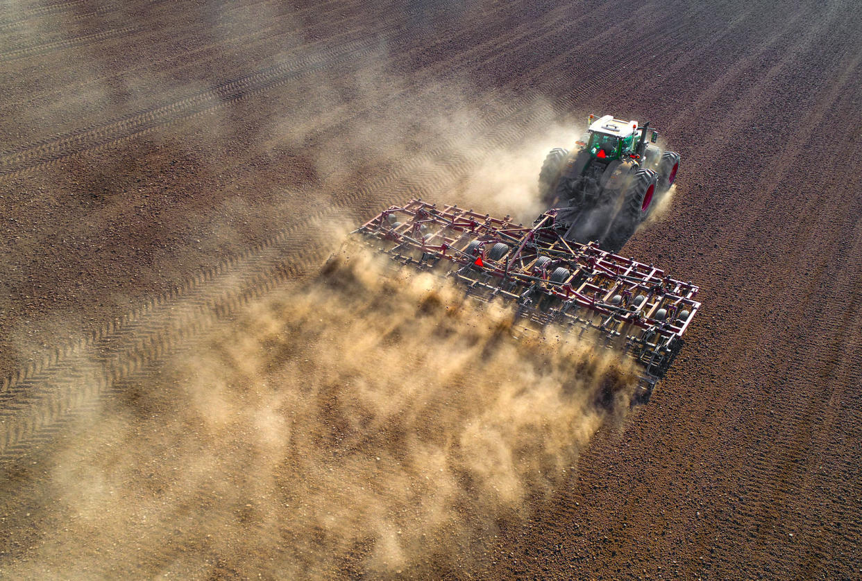 Big farm tractor tilling dusty Springtime fields Getty Images/JamesBrey