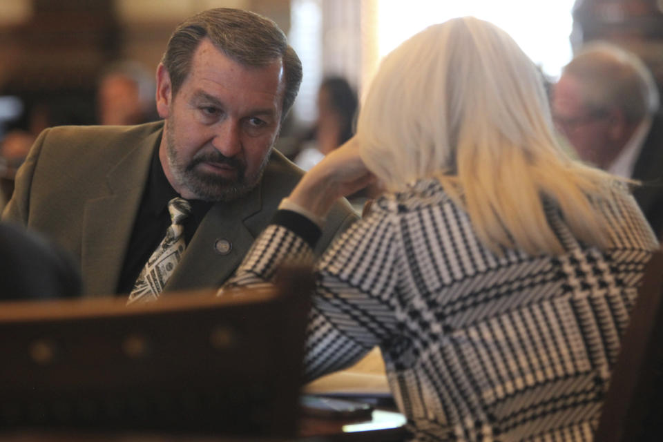 In this photo from Wednesday, March 27, 2024, state Sen. Virgil Peck, left, R-Havana, confers with Sen. Renee Erickson, R-Wichita, during the Senate's session, at the Statehouse in Topeka, Kan. Both senators support several anti-abortion measures, including one to make it a crime to coerce someone into having an abortion. (AP Photo/John Hanna)