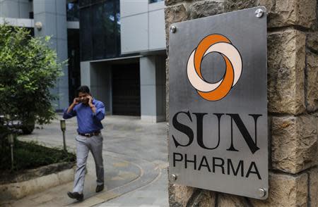 An employee speaks on phone as he walks out of research and development centre of Sun Pharmaceutical Industries Ltd in Mumbai April 7, 2014. REUTERS/Danish Siddiqui