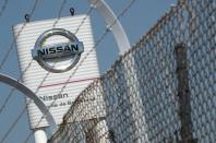 FILE PHOTO: The logo of Nissan is seen through a fence at Nissan factory at Zona Franca during the coronavirus disease (COVID-19) outbreak in Barcelona