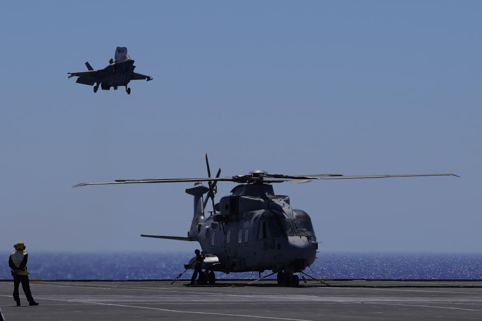 F-35 aircraft landing on the U.K.'s aircraft carrier HMS Queen Elizabeth in the Mediterranean Sea on Sunday, June 20, 2021. The British Royal Navy commanders say the U.K.'s newest aircraft carrier HMS Queen Elizabeth is helping to take on the "lion's share" of operations against the Islamic State group in Iraq as Russian warplanes get an up-close look at the cutting-edge F-35 jet in a "cat-and-mouse" game with British and U.S. pilots. (AP Photo/Petros Karadjias)