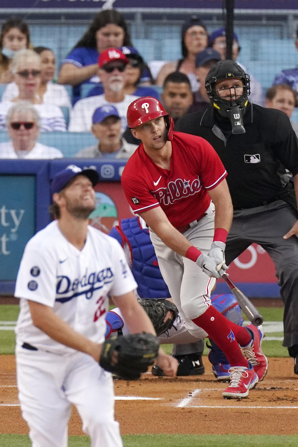 Philadelphia Phillies' Rhys Hoskins, center, hits a solo home run as Los Angeles Dodgers starting pitcher Clayton Kershaw, left, watches along with umpire Manny Gonzalez during the first inning of a baseball game Wednesday, June 16, 2021, in Los Angeles. (AP Photo/Mark J. Terrill)