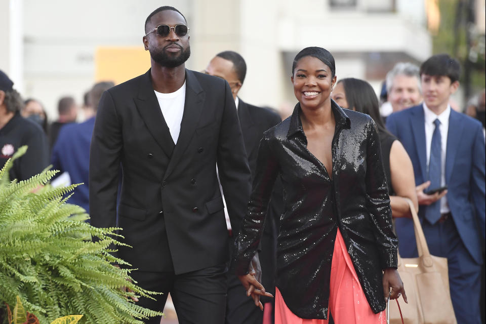 Dwyane Wade and Gabrielle Union walk the red carpet for the 2021 Basketball Hall of Fame Enshrinement ceremony, Saturday, Sept. 11, 2021, in Springfield, Mass. (AP Photo/Jessica Hill)