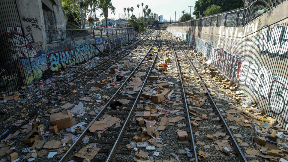 Shredded boxes and packages and debris are strewn along at a section of the Union Pacific train tracks in downtown Los Angeles Friday, Jan. 14, 2022. Thieves have been raiding cargo containers aboard trains nearing downtown Los Angeles for months, leaving the tracks blanketed with discarded packages. The sea of debris left behind included items that the thieves apparently didn't think were valuable enough to take, CBSLA reported Thursday. (AP Photo/Ringo H.W. Chiu)