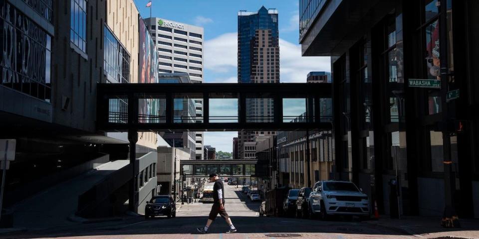 St. Paul, Minnesota: A man walks across the street in an almost empty downtown due to the coronavirus lockdown.