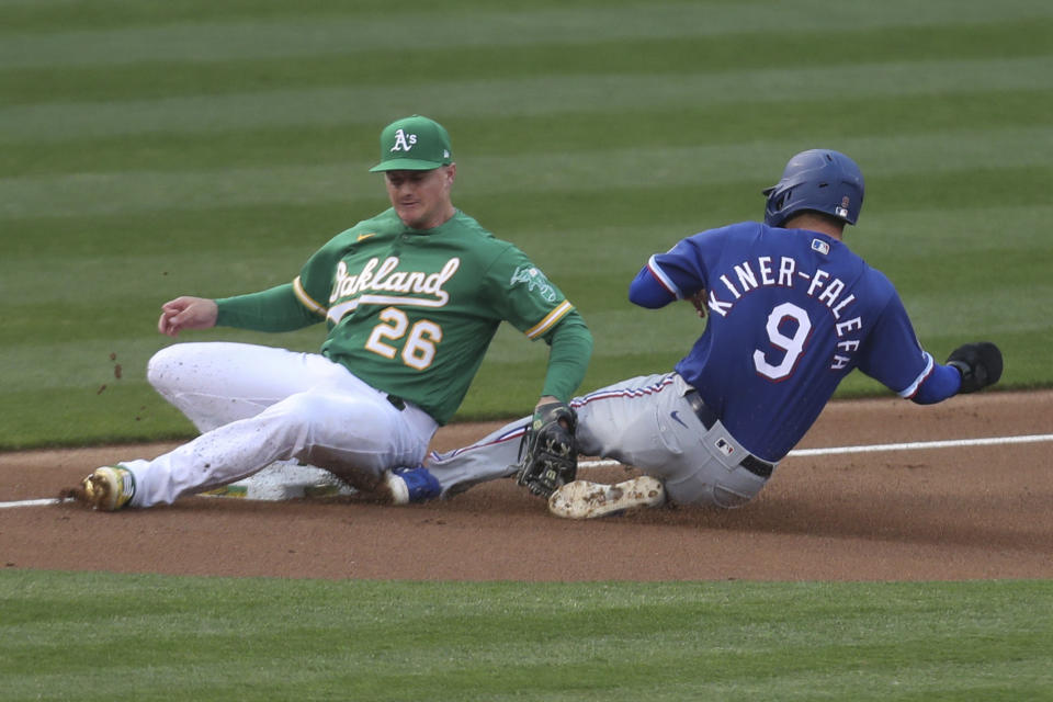 Oakland Athletics third baseman Matt Chapman tags out Isiah Kiner-Falefa of the Texas Rangers on an attempted steal during the third inning of a baseball game in Oakland, Calif., Tuesday, Aug. 4, 2020. (AP Photo/Jed Jacobsohn)