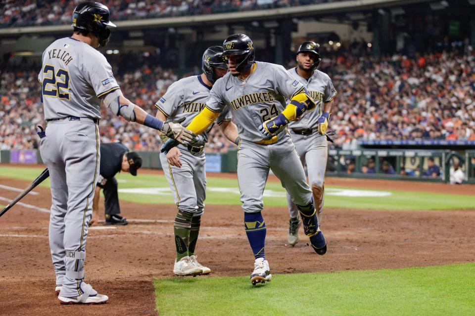 Brewers catcher William Contreras is congratulated by Christian Yelich after hitting a three-run home run Saturday night in the fifth inning of Milwaukee's victory over the Astros in Houston.