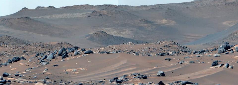 a reddish-brown landscape of sand and rocks