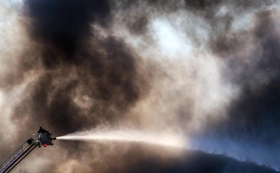 A massive fire burns inside a Walmart fulfillment center in Plainfield, Ind., near the Indianapolis International Airport.