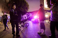 LOS ANGELES, CA - JUNE 11: Two fans block the path of a Los Angeles Police Department squad car after the Los Angeles Kings defeated the New Jersey Devils to win the 2012 Stanley Cup Final June 11, 2012 in Los Angeles, California. The win is the Los Angeles Kings first championship in franchise history. (Photo by Jonathan Gibby/Getty Images)