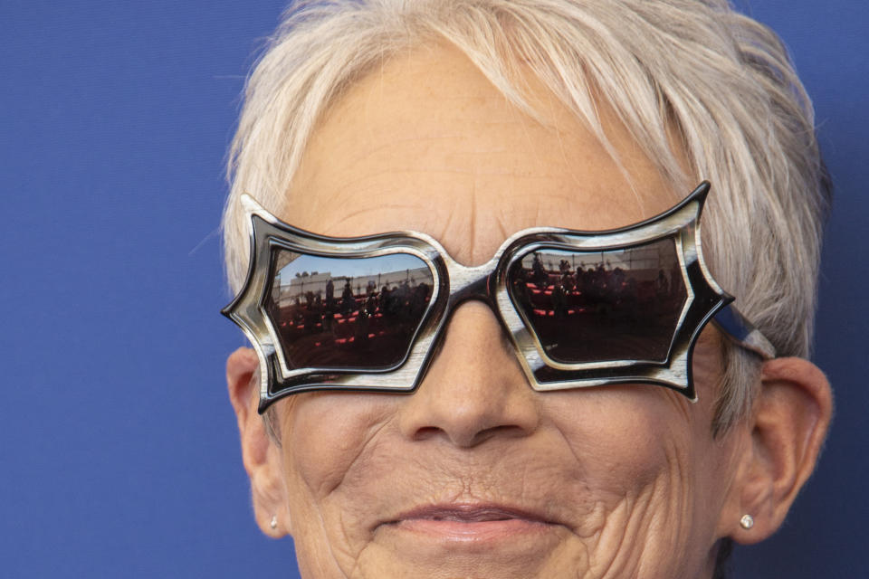 FILE - In this Sept, 8, 2021 file photo Jamie Lee Curtis poses for photographers, reflected in glasses, at the photo call for the film 'Halloween Kills' during the 78th edition of the Venice Film Festival in Venice, Italy. (Photo by Joel C Ryan/Invision/AP, File)