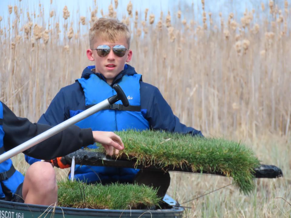 Braden Meyer of Grafton holds a section of a nesting platform being installed at Mud Lake in Cedarburg Bog. The platform is intended to provide a nesting site for black terns, a state-endangered species. Meyer built five of the platforms as part of his Eagle Scout project.