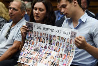 Tomra Vecere, center, and Tor Stumo, right, hold a poster with some of the victims of Ethiopian Airlines Flight 302 before the start of House Transportation subcommittee hearing on Capitol Hill in Washington, Wednesday, July 17, 2019, on aviation safety. (AP Photo/Susan Walsh)