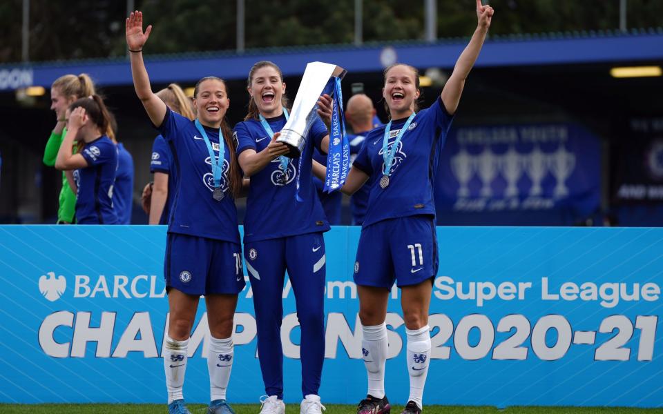 Chelsea players celebrate with the FA Women's Super League trophy after clinching the title at Kingsmeadow, London. Picture date: Sunday May 9, 2021 - PA