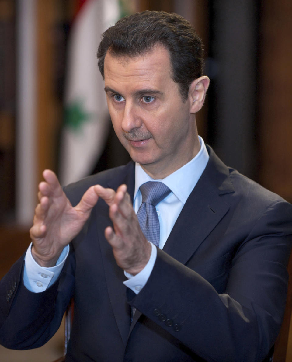 In this photo released by the Syrian official news agency SANA, Syrian President Bashar Assad speaks during an interview in Damascus, Syria, Sunday, Jan. 19, 2014. Syria has been ruled by President Bashar Assad's family since 1970, and Iran is Assad's strongest regional ally, supplying his government with advisers, money and materiel since the uprising began in 2011. (AP Photo/SANA)