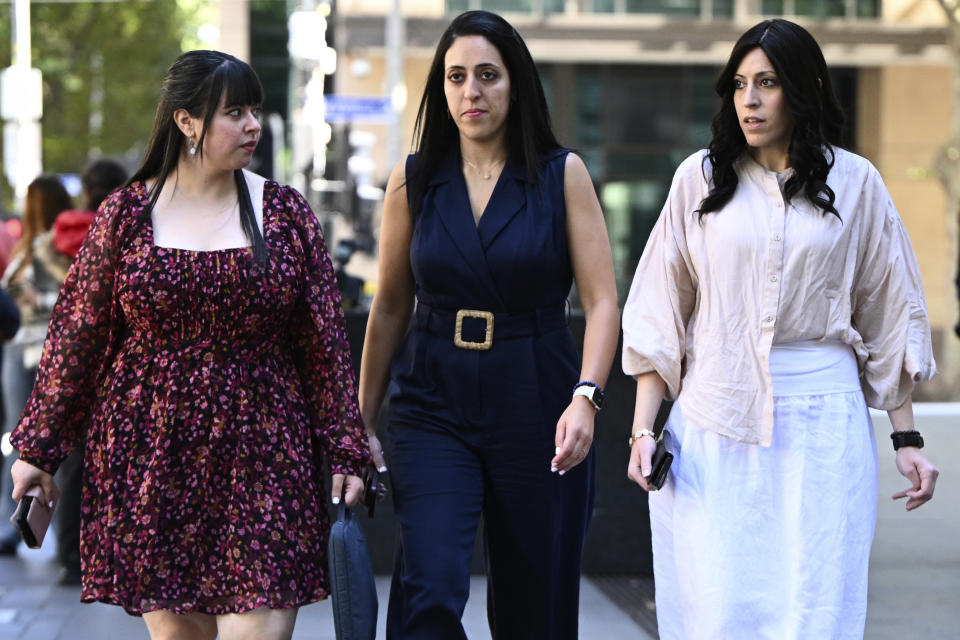 Sisters Dassi Erlich, left, Elly Sapper and Nicole Meyer, right, leave the County Court of Victoria in Melbourne, Monday, April 3, 2023, during the trial of Malka Leifer accused of sexually abusing students. Leifer, a former principal of a Jewish girls school was found guilty sexually abusing two students. (Joel Carrett/AAP Image via AP)