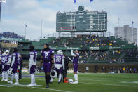 Iowa and Northwestern players warm up before an NCAA college football game Saturday, Nov. 4, 2023, at Wrigley Field in Chicago. (AP Photo/Erin Hooley)