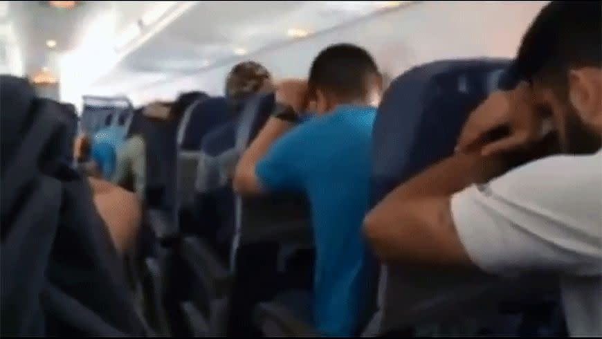 Passengers adopt the brace position during landing. Photo: Youtube