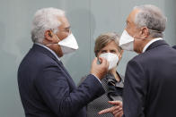 Portuguese President Marcelo Rebelo de Sousa, right, Prime Minister Antonio Costa, left, and Health Minister Marta Temido talk at the end of a visit to the Military Hospital in Lisbon, Tuesday, Jan. 26, 2021. The military hospital is expanding it's number of beds available to take COVID-19 patients from the National Health Service. Portugal is reporting new daily records of COVID-19 deaths and hospitalizations as a recent pandemic surge continues unabated. (AP Photo/Armando Franca)