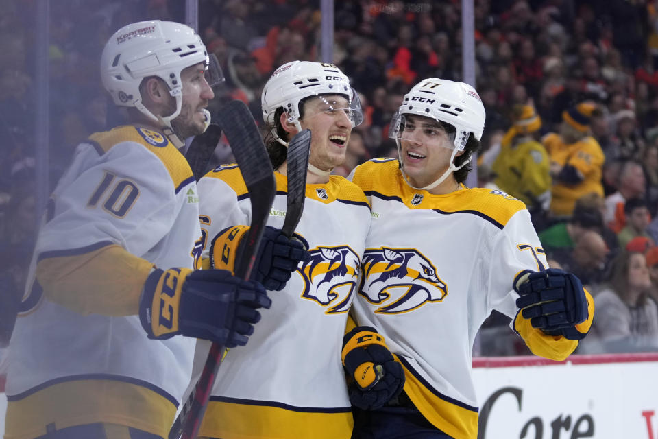 Nashville Predators' Philip Tomasino, center, celebrates with Luke Evangelista, right, and Colton Sissons after scoring a goal during the third period of an NHL hockey game against the Philadelphia Flyers, Thursday, Dec. 21, 2023, in Philadelphia. (AP Photo/Matt Slocum)