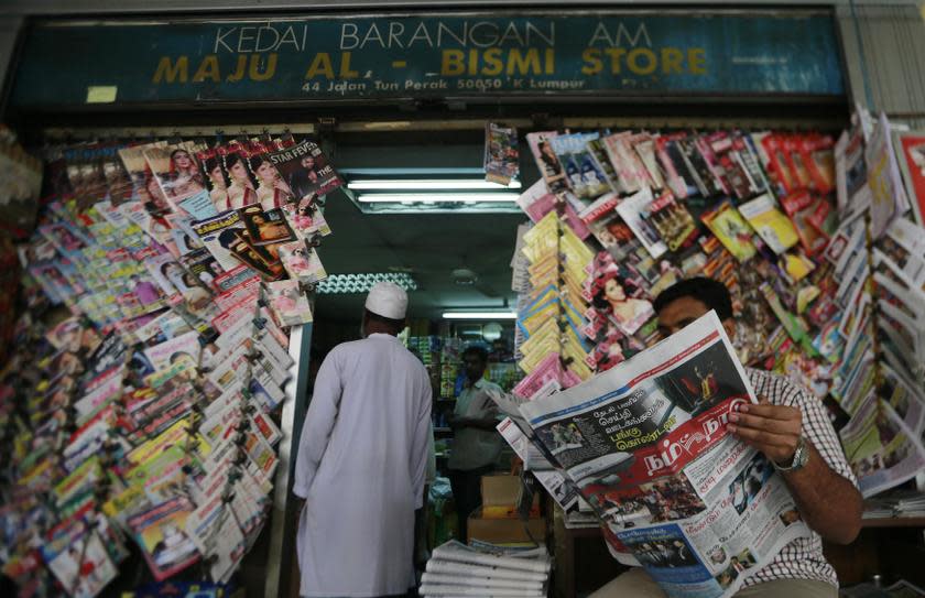 A man reads a Tamil newspaper in Kuala Lumpur March 14, 2014. — Reuters pic