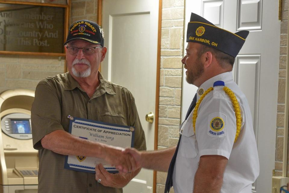William “Bill” Sorg, left, was one of eight Purple Heart recipients who were honored at American Legion Post 114 on Saturday. He received a certificate from Ben Knauss, Commander of American Legion Post 114 in Oak Harbor.
