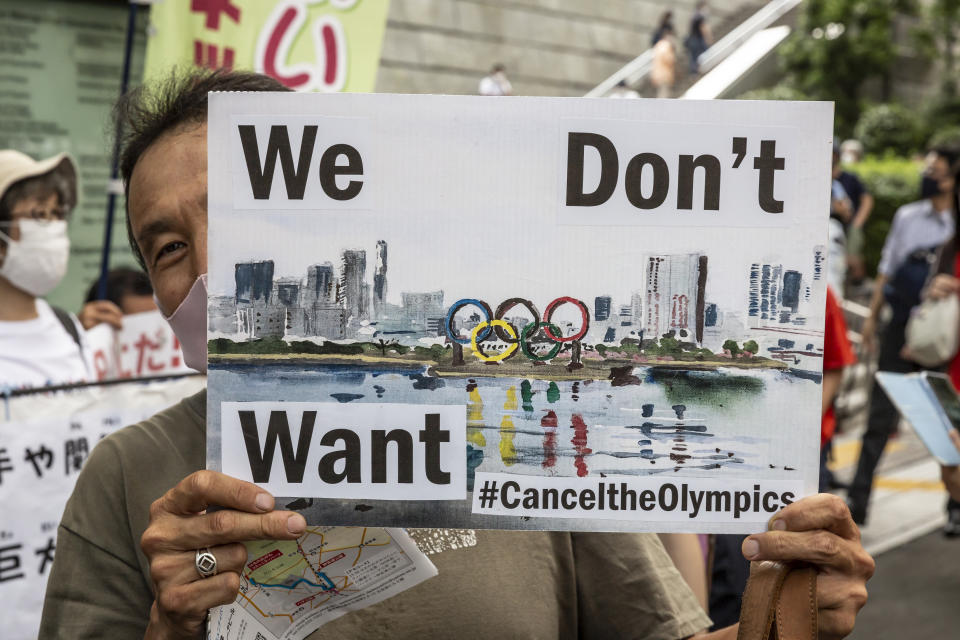 TOKYO, JAPAN - JULY 23: An anti-Olympics protester demonstrates during the Olympic Torch Relay Celebration event on July 23, 2021 in Tokyo, Japan. Protesters gathered to demonstrate against the Olympic Games amid concern over the safety of holding the event during the global coronavirus pandemic as well as the cost incurred. (Photo by Yuichi Yamazaki/Getty Images)