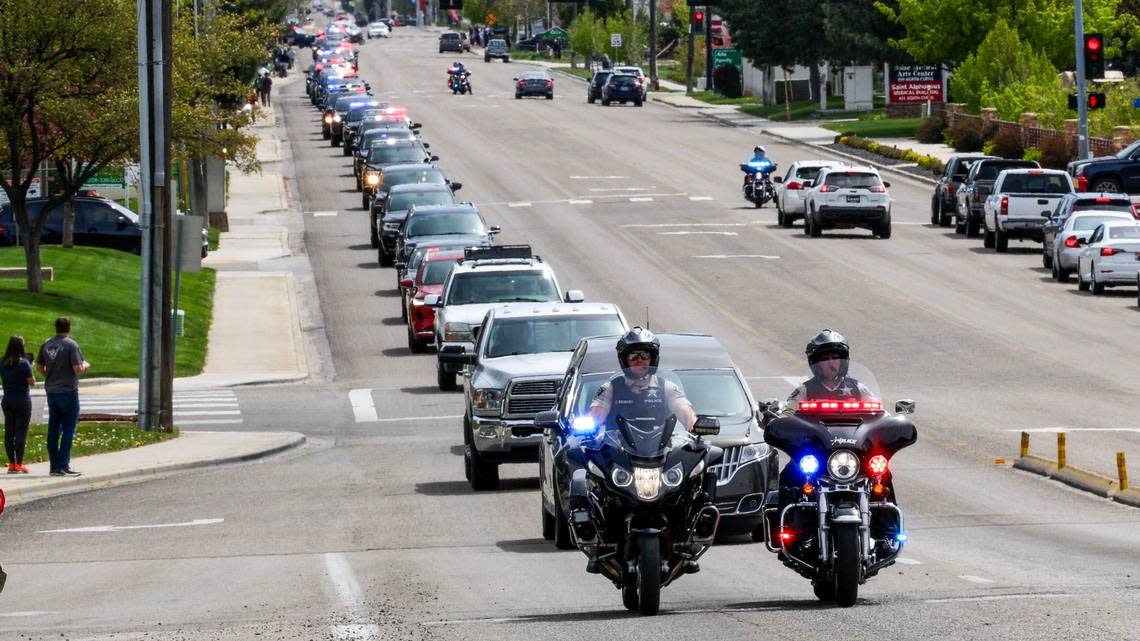 A police procession escorts Ada County Sheriff’s Office Deputy Tobin Botler from the Ada County Coroner’s Office to a funeral home Sunday in Boise The 27-year-old was shot during a traffic stop Saturday night.