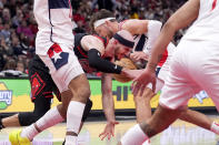 Chicago Bulls' Alex Caruso, left, loses the ball to Washington Wizards' Corey Kispert during the second half of an NBA basketball game Monday, March 25, 2024, in Chicago. The Wizards won 107-105. (AP Photo/Charles Rex Arbogast)
