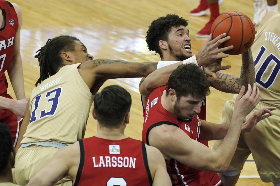 Washington forward Hameir Wright (13) and Utah forward Timmy Allen upper right, battle for the ball during the first half of an NCAA college basketball game, Sunday, Jan. 24, 2021, in Seattle. (AP Photo/Ted S. Warren)