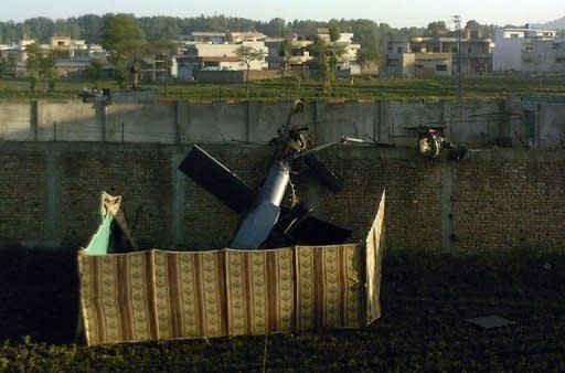 A crashed military helicopter is seen near the hideout of Al-Qaeda leader Osama bin Laden after a ground operation by US Special Forces in Abbottabad in 2011. An unarmed bin Laden was shot in the head as he peered out of a doorway and then pumped with bullets as he convulsed on the floor, according to a book by the US commando team that killed him