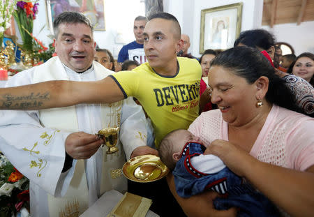 Roma celebrate during a christening in the chapel in Csatka, Hungary on September 9, 2017. REUTERS/Laszlo Balogh