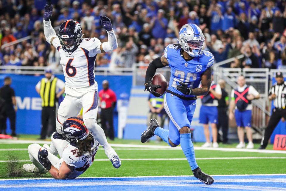 Detroit Lions running back Jahmyr Gibbs (26) runs into the end zone for a touchdown against Denver Broncos linebacker Alex Singleton (49) during the first half at Ford Field in Detroit on Saturday, Dec. 16, 2023.