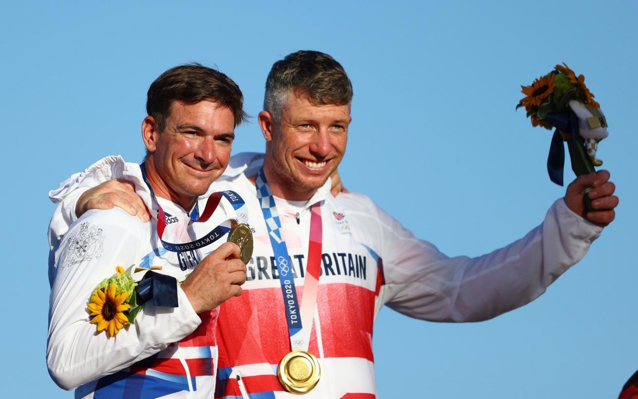 Dylan Fletcher (L) and Stuart Bithell of Team Great Britain pose with their gold medals for the Men's Skiff 49er - Getty Images