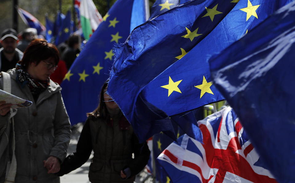 Protestor flags fly opposite the Houses of Parliament in London, Thursday, April 11, 2019. European Union leaders on Thursday offered Britain an extension to Brexit that would allow the country to delay its EU departure date until Oct. 31. (AP Photo/Frank Augstein)