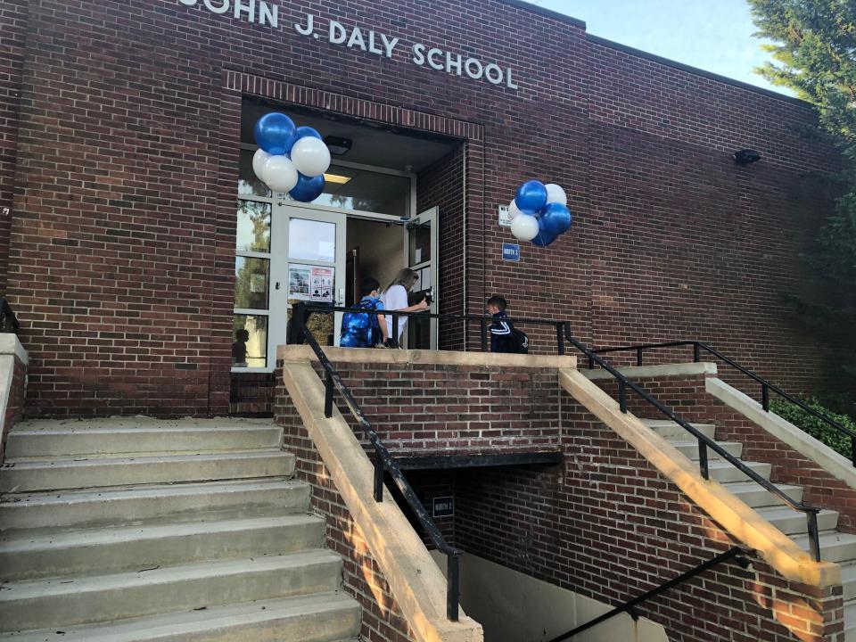 Third-grader Benjamin Cincu walks into John J. Daly Elementary School in Port Washington with his friend on the first day of school.