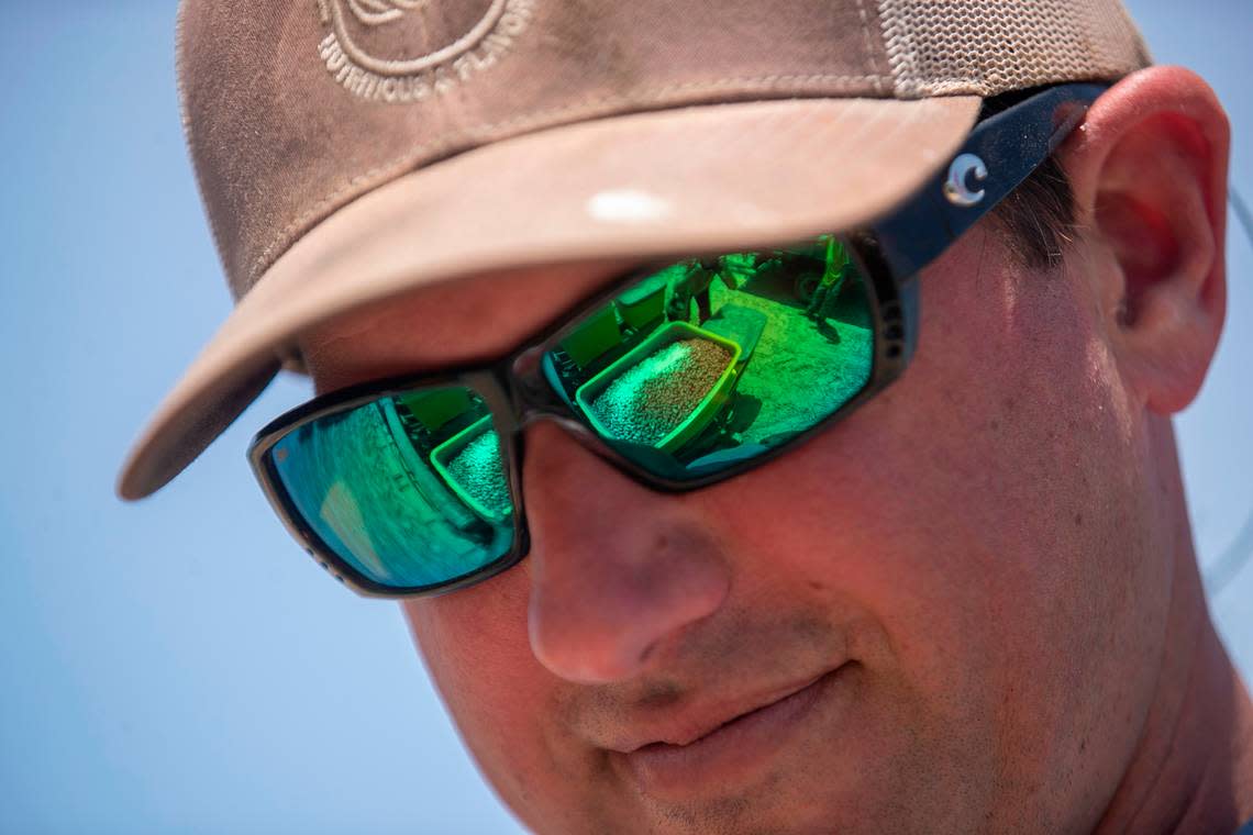 Seed peanuts are reflected in the glasses of farmer Donny Lassiter as they are loaded into planting equipment on Friday, May 12, 2023 in Pendleton, N.C. Lassiter grows more than 1,500 acres of peanuts in an around Northampton County, North Carolina.