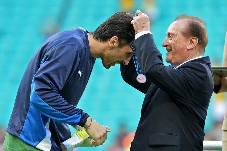 The president of the South American Football Confederation (CONMEBOL), Uruguayan Eugenio Figueredo (R) gives the bronze medal to Italy's goalkeeper Gianluigi Buffon after Italy defeated Uruguay 3-2 in the penalty shoot-out of their FIFA Confederations Cup Brazil 2013 third-place football match, at the Fonte Nova Arena in Salvador, on June 30, 2013