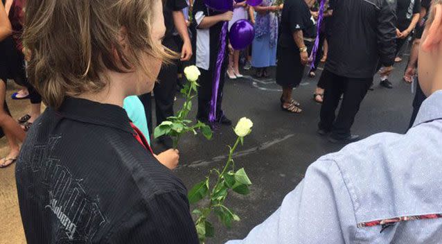 People held white roses. Source: 7 News.