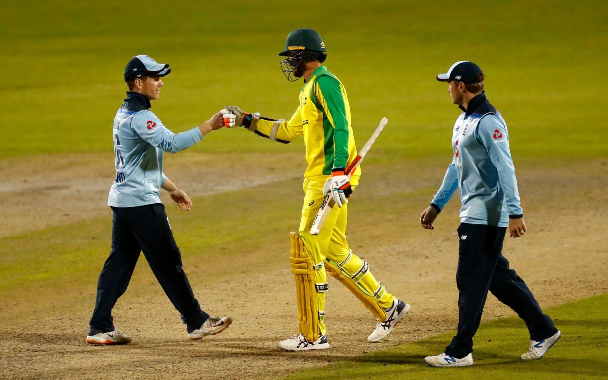 Australia's Mitchell Starc (centre) shakes hands with England's Eoin Morgan - PA