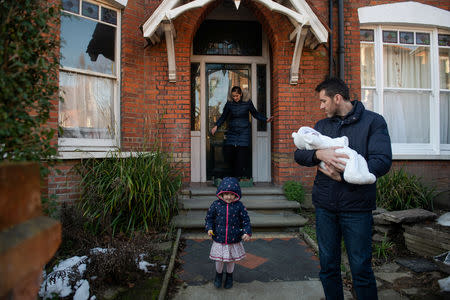 Adi, 37, who works for a removal company and his wife, Maria, 31, take their daughters, Elena, who is two years and seven-months old, and baby Ioana, who is less than a week old, for a walk in Hampstead Heath near their home in London, Britain, February 3, 2019. REUTERS/Alecsandra Dragoi