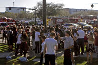 <p>Students are released from a lockdown following a shooting at Marjory Stoneman Douglas High School in Parkland, Fla., on Feb. 14, 2018. (Photo: John McCall/South Florida Sun-Sentinel via AP) </p>