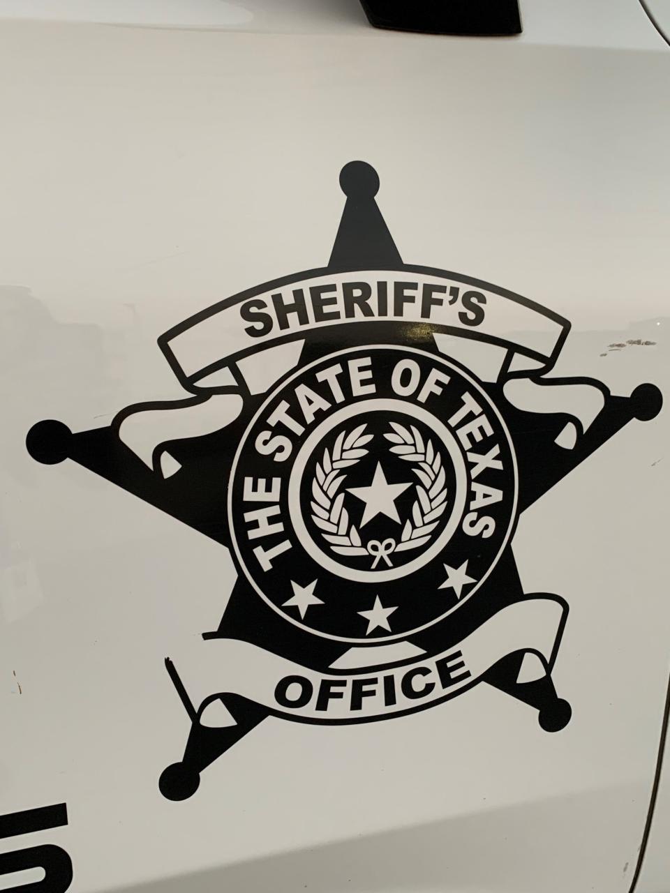 The well-worn Texas seal on the side of the deputy's vehicle.