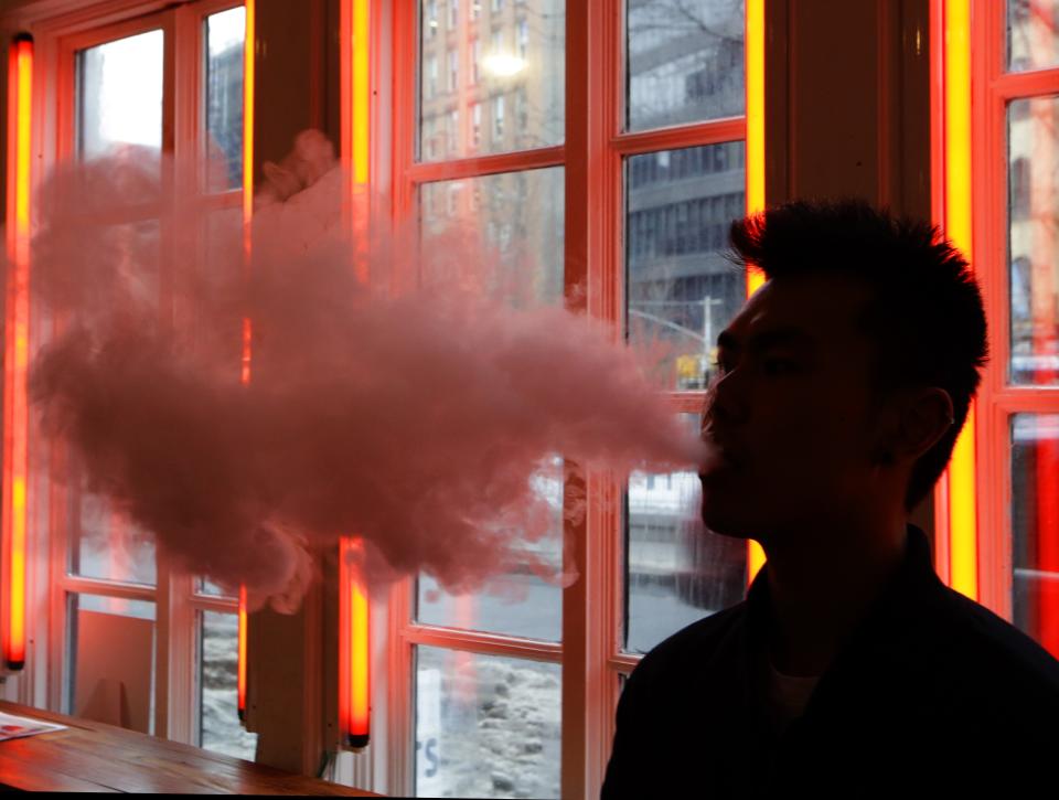 In this Feb. 20, 2014 photo, a patron exhales vapor from an e-cigarette at the Henley Vaporium in New York. the proprietors are peddling e-cigarettes to "vapers" in a growing movement that now includes celebrity fans and YouTube gurus, online forums and vapefests around the world. (AP Photo/Frank Franklin II)