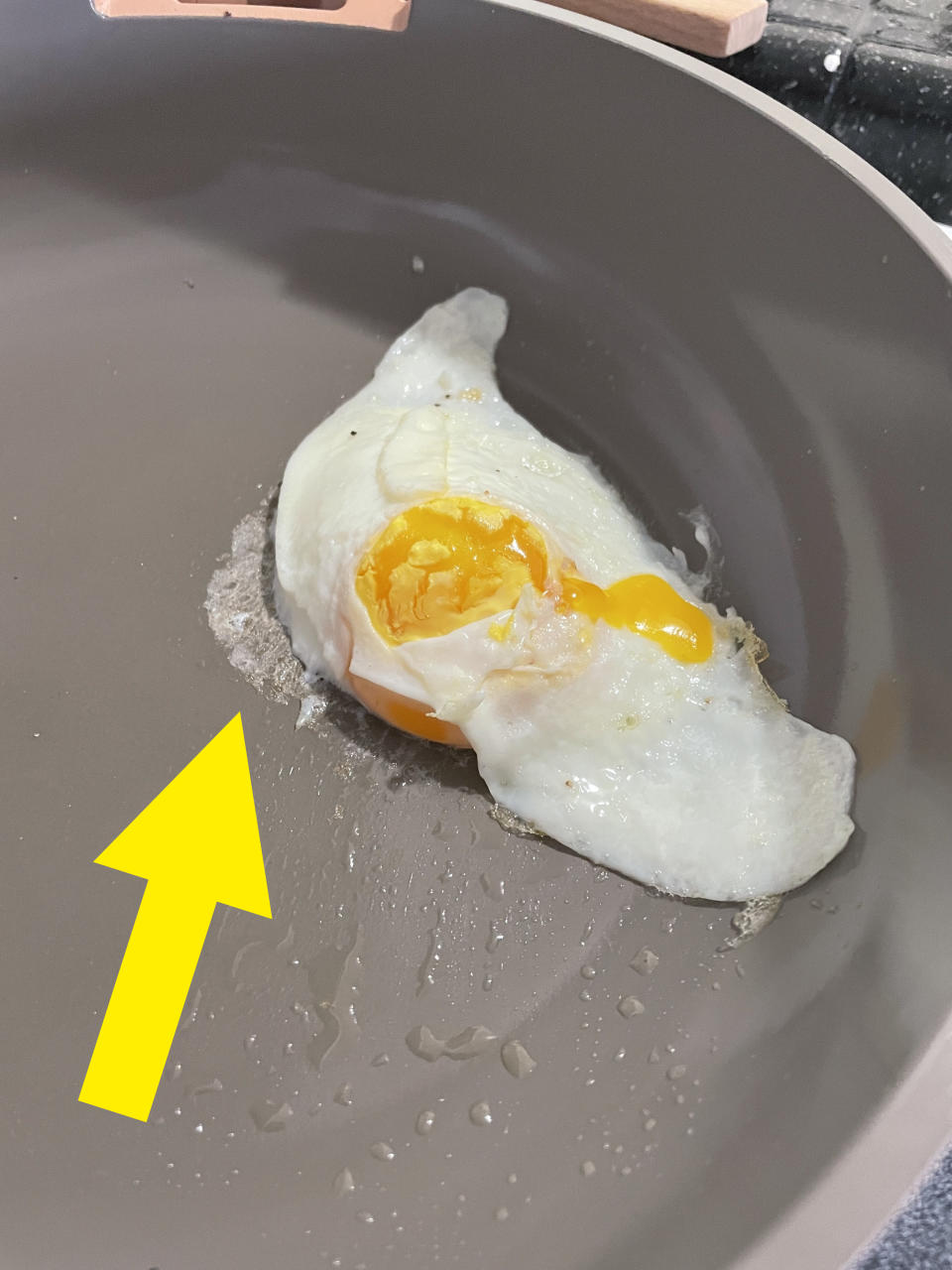 Over-easy egg in the pan with some leaking