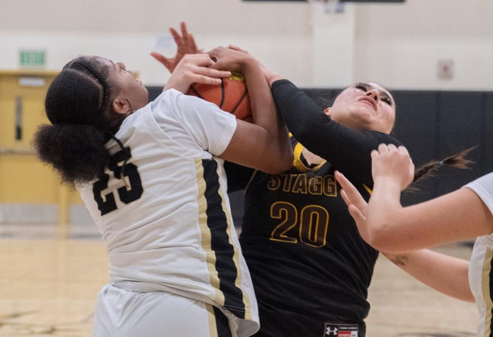 Chavez's Amora Hendon, left, fights for a rebound with Stagg's Destiny Martinez during a girls varsity basketball game at Chavez High School in Stockton on Jan. 18, 2024.